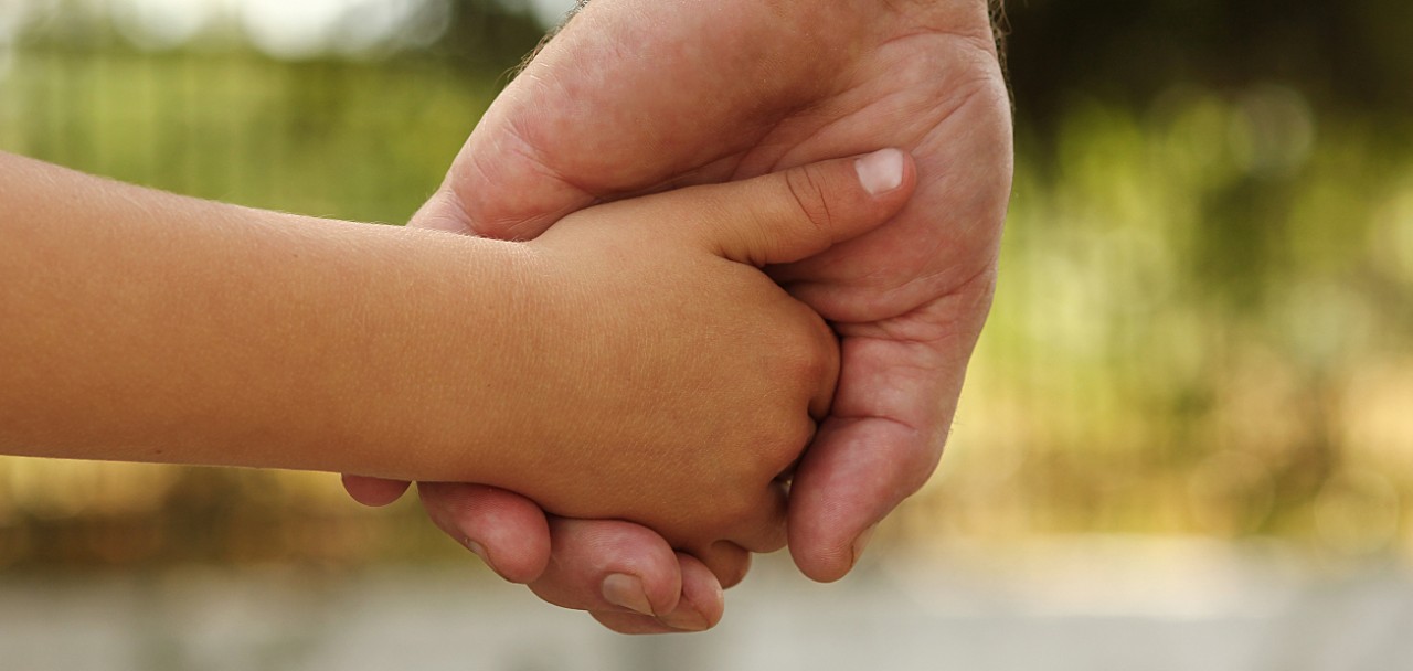 a the parent holds the hand of a small child; Shutterstock ID 340837913; PO: 123